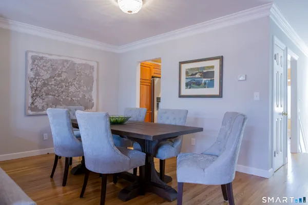 a view of a dining room with furniture and wooden floor
