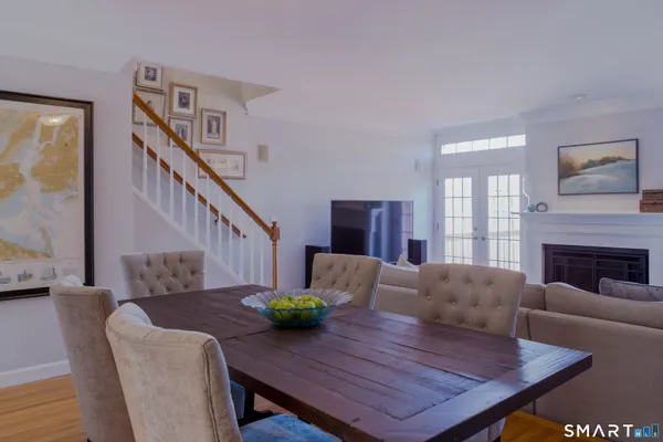 a living room with furniture fireplace and a window