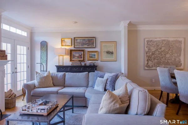 a living room with furniture and painting on the wall