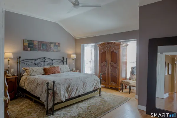 a bedroom with a bed and a mirror