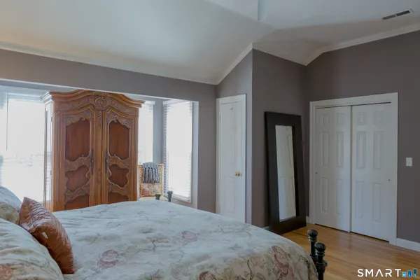 a bedroom with a bed and a dresser