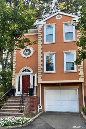 a view of a house with a yard and garage
