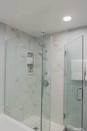 a bathroom with a shower and a mirror