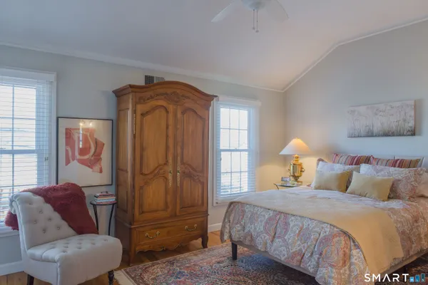 a bedroom with a bed and a couch