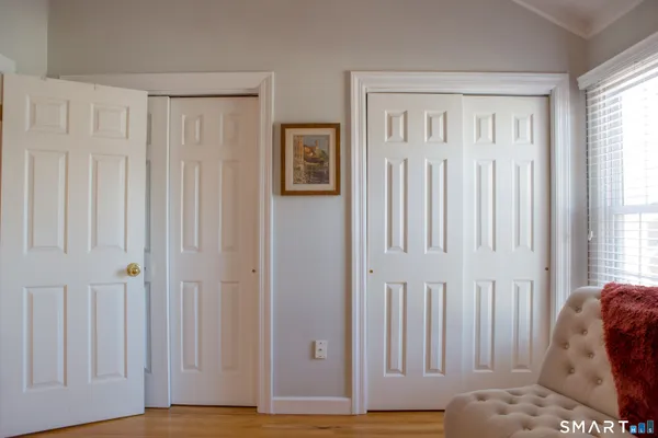 a view of a livingroom with wooden floor and a window