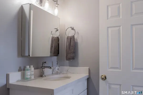 a bathroom with a sink vanity and a mirror