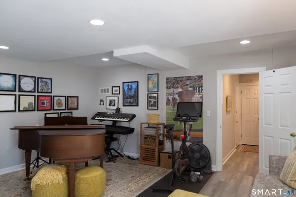 a room with furniture a rug and a bookshelf