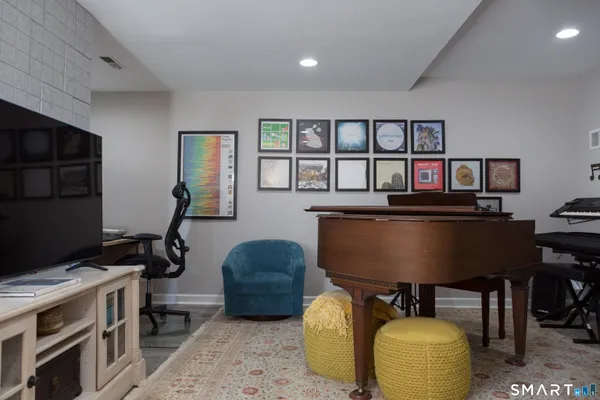 a view of a workspace with furniture and a window