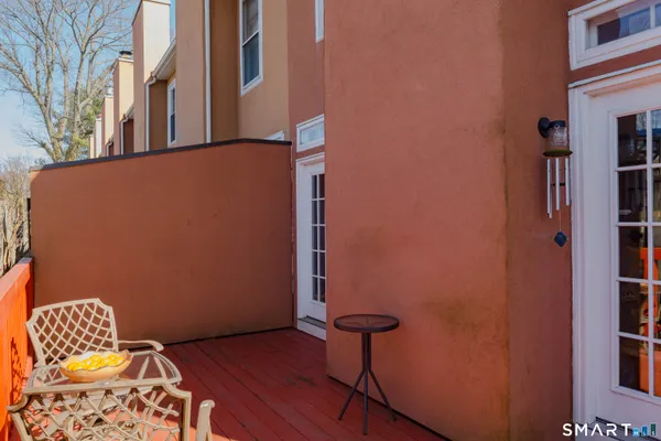 a view of a brick building with a small yard and plants