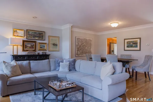 a living room with furniture and painting on the wall