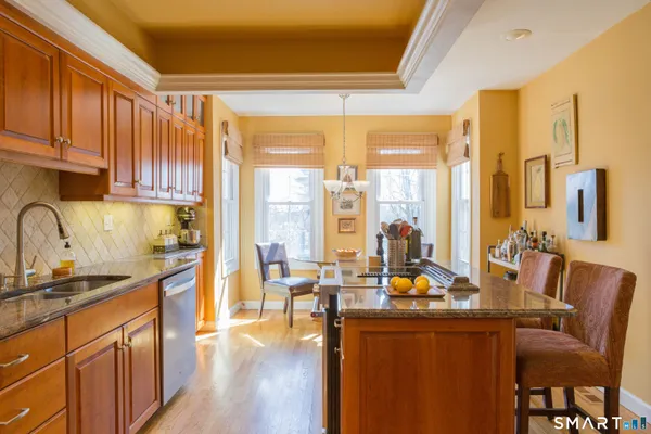 a kitchen with stainless steel appliances wooden cabinets a sink and a stove