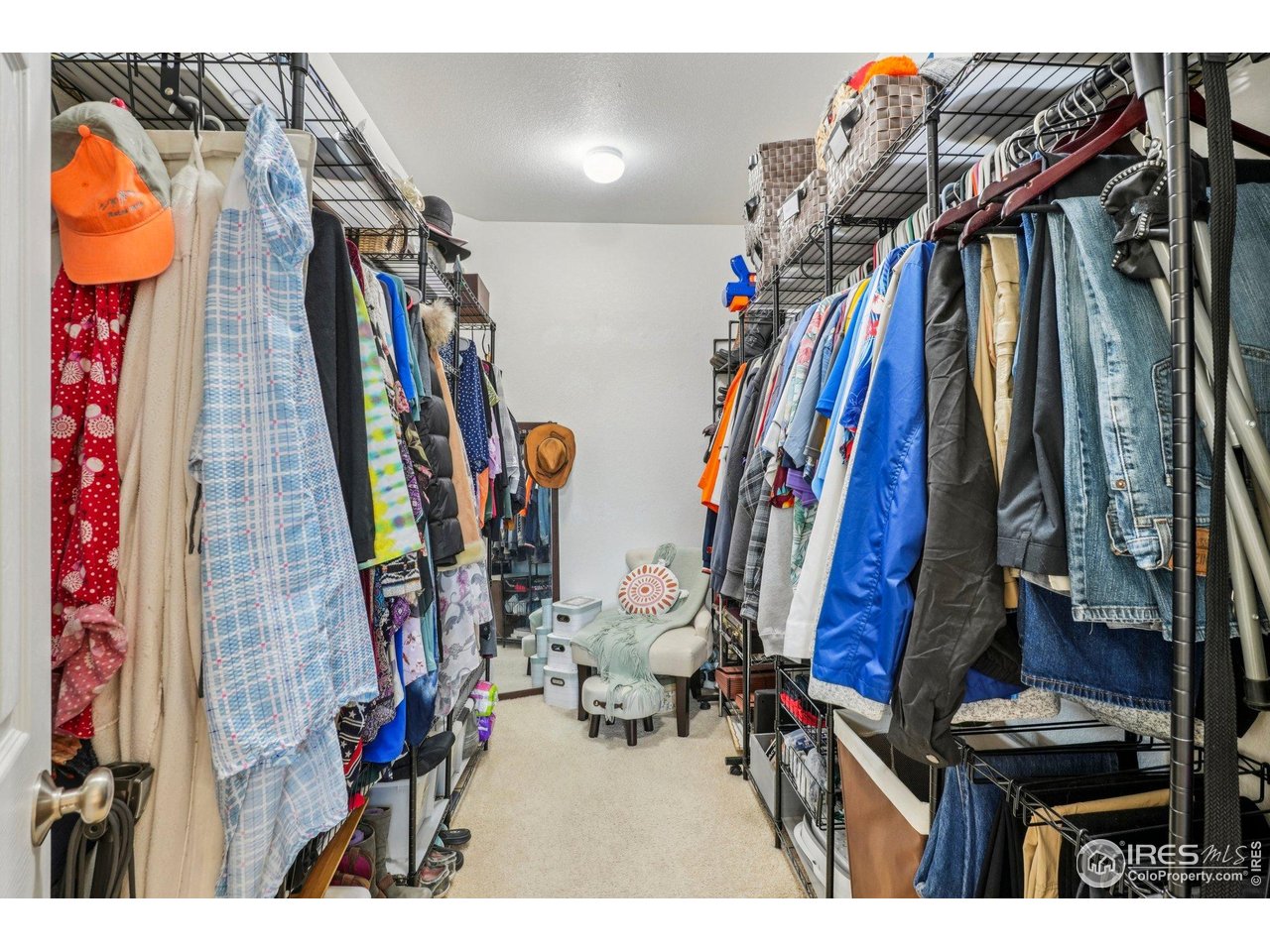256 Homestead Way Brighton, CO 80601 - Photo 20 of 42 a view of walk in closet with clothes