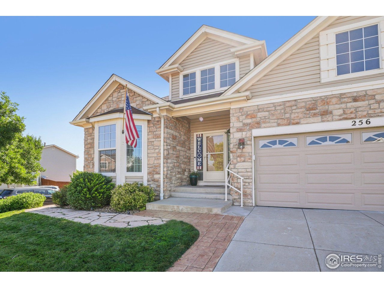 256 Homestead Way Brighton, CO 80601 - Photo 2 of 42 a front view of a house with a yard