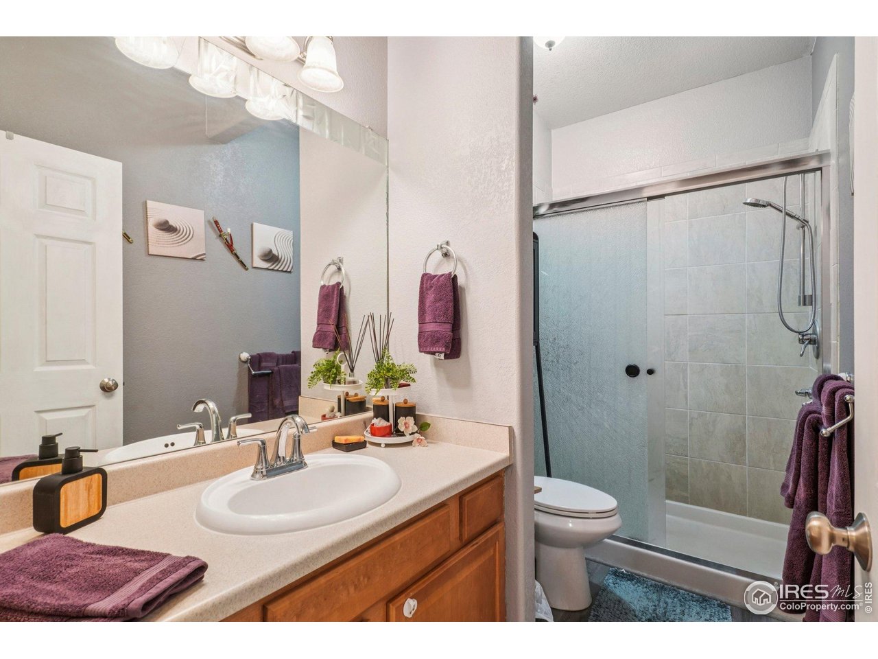 256 Homestead Way Brighton, CO 80601 - Photo 22 of 42 a bathroom with a granite countertop sink mirror vanity and toilet