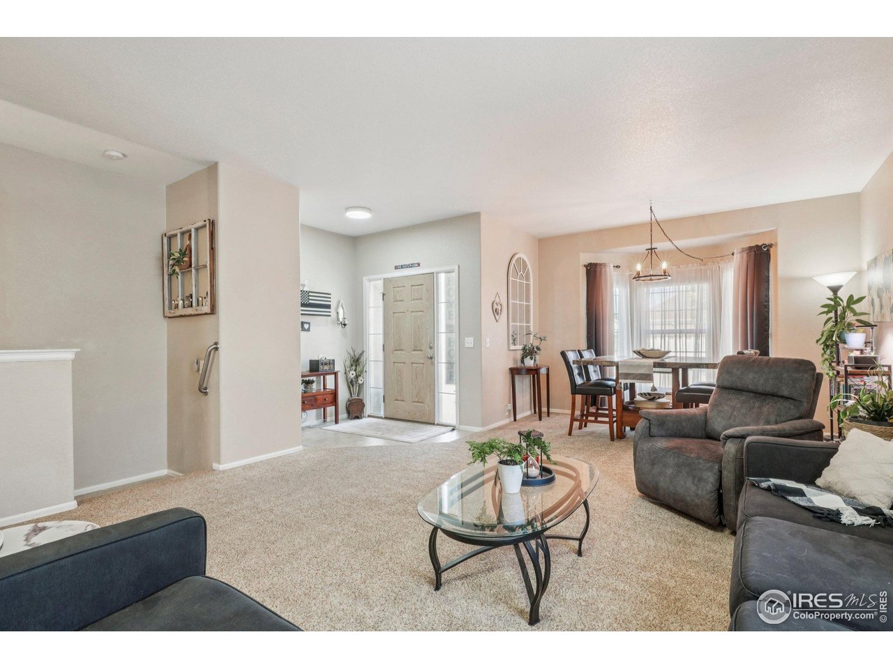 256 Homestead Way Brighton, CO 80601 - Photo 6 of 42 a living room with furniture and a wooden floor