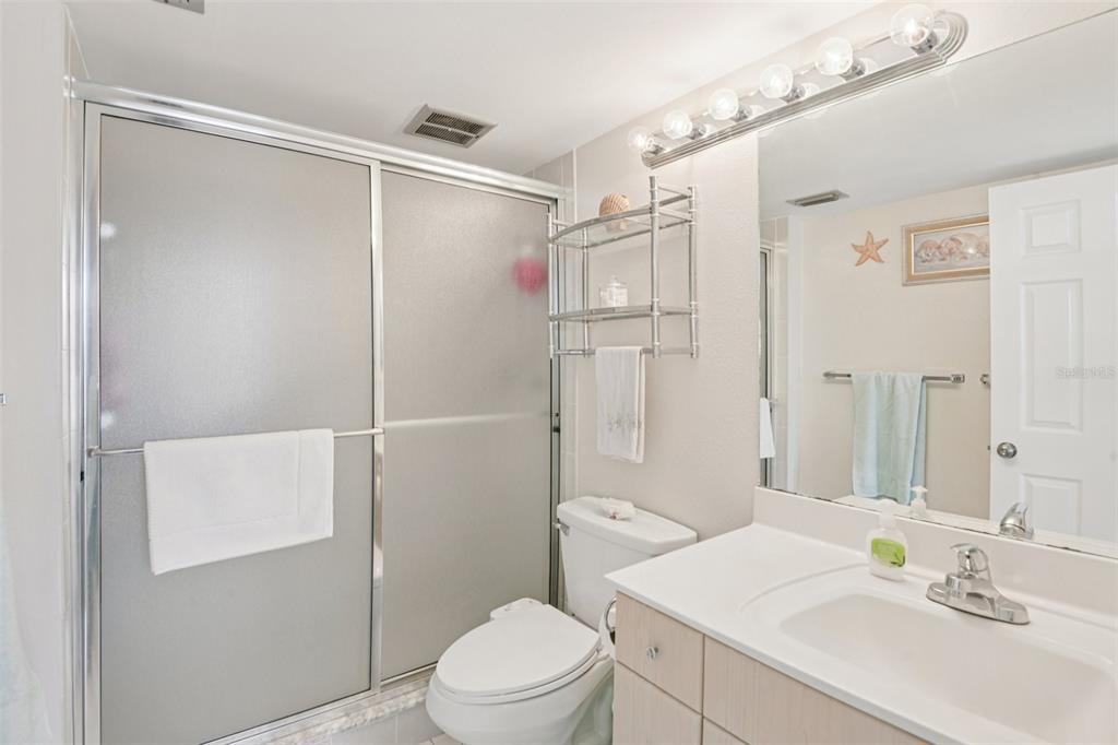 18304 Gulf Boulevard, Unit 607 Redington Shores, FL 33708 - Photo 14 of 30 a bathroom with a sink toilet and shower