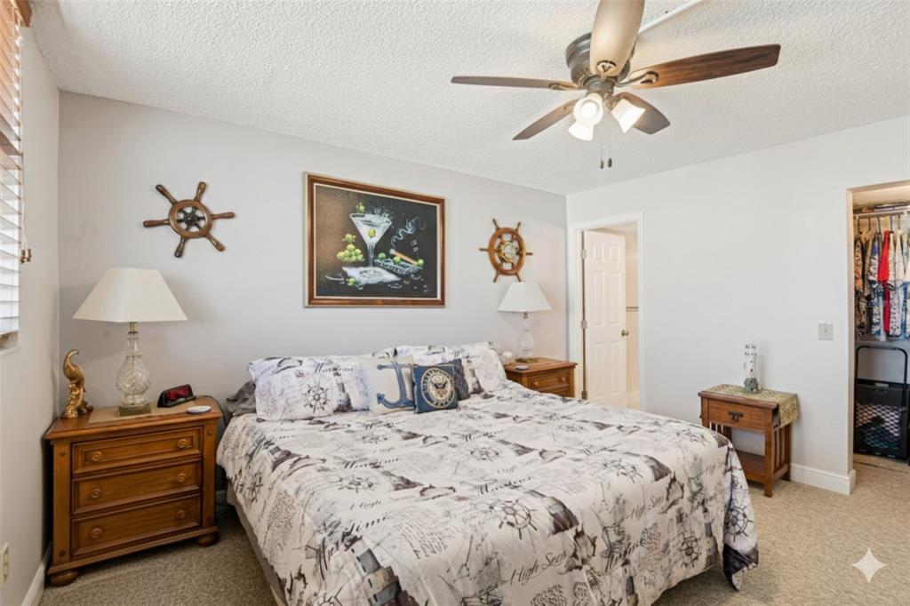 18304 Gulf Boulevard, Unit 607 Redington Shores, FL 33708 - Photo 16 of 30 a bedroom with a bed and a chandelier