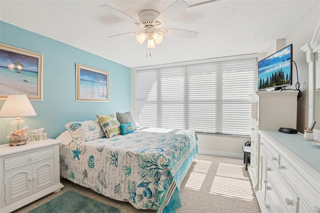 18304 Gulf Boulevard, Unit 607 Redington Shores, FL 33708 - Photo 18 of 30 a bedroom with a bed and a flat screen tv