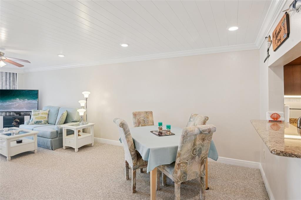 18304 Gulf Boulevard, Unit 607 Redington Shores, FL 33708 - Photo 7 of 30 a living room with furniture a flat screen tv and a table