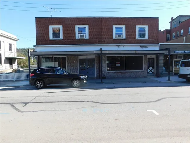 a view of a car parked in front of a building