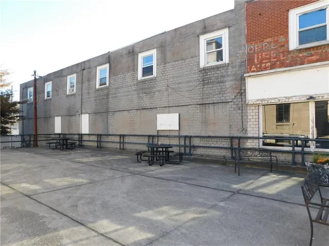 a view of a house with two chairs and a large window