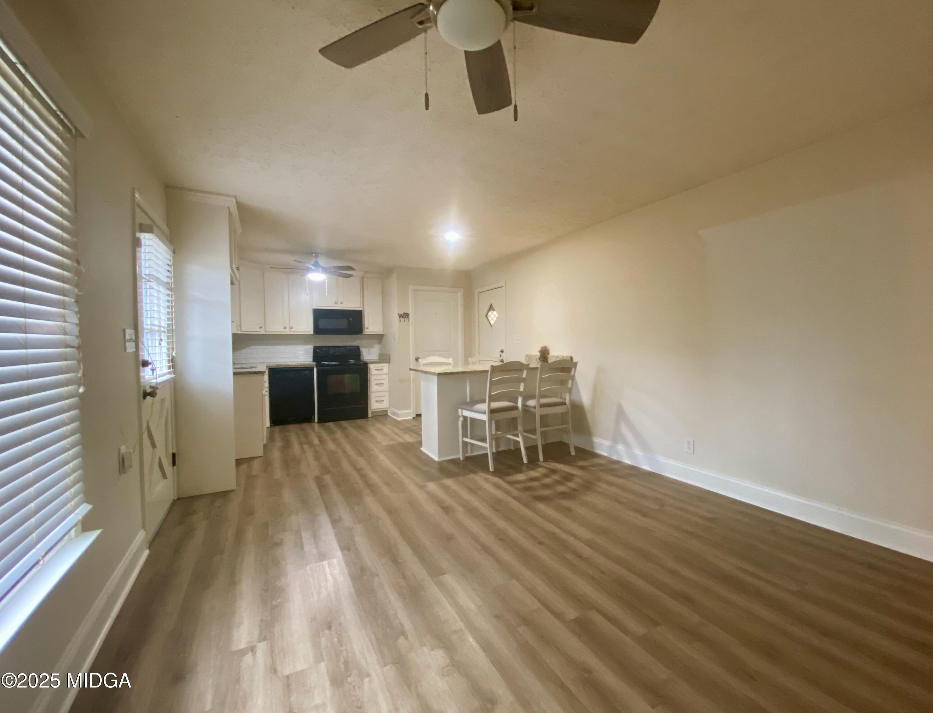727 Walker Road Byron, GA 31008 - Photo 4 of 23 a view of a kitchen with furniture and a ceiling fan