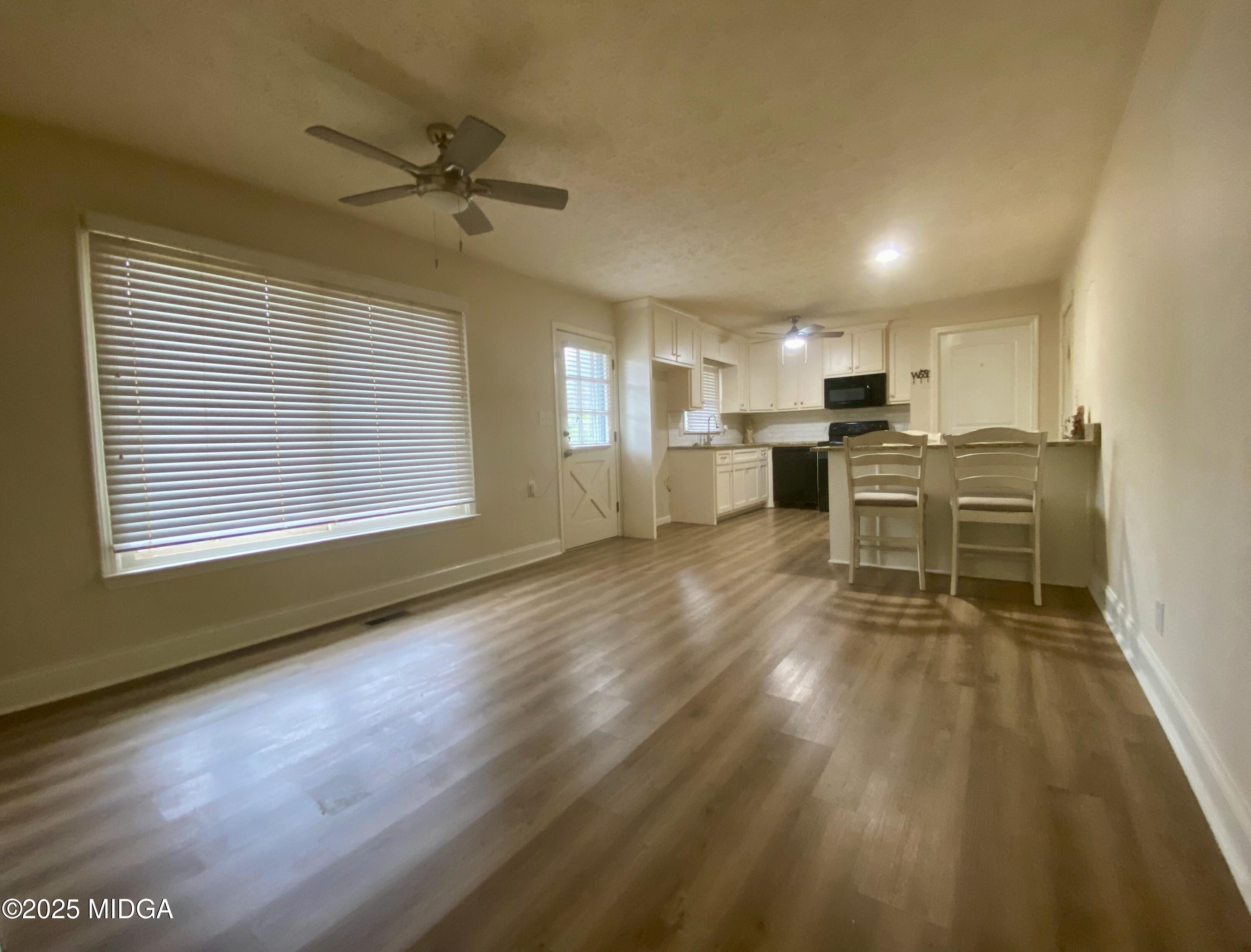 727 Walker Road Byron, GA 31008 - Photo 5 of 23 a living room with furniture and a wooden floor