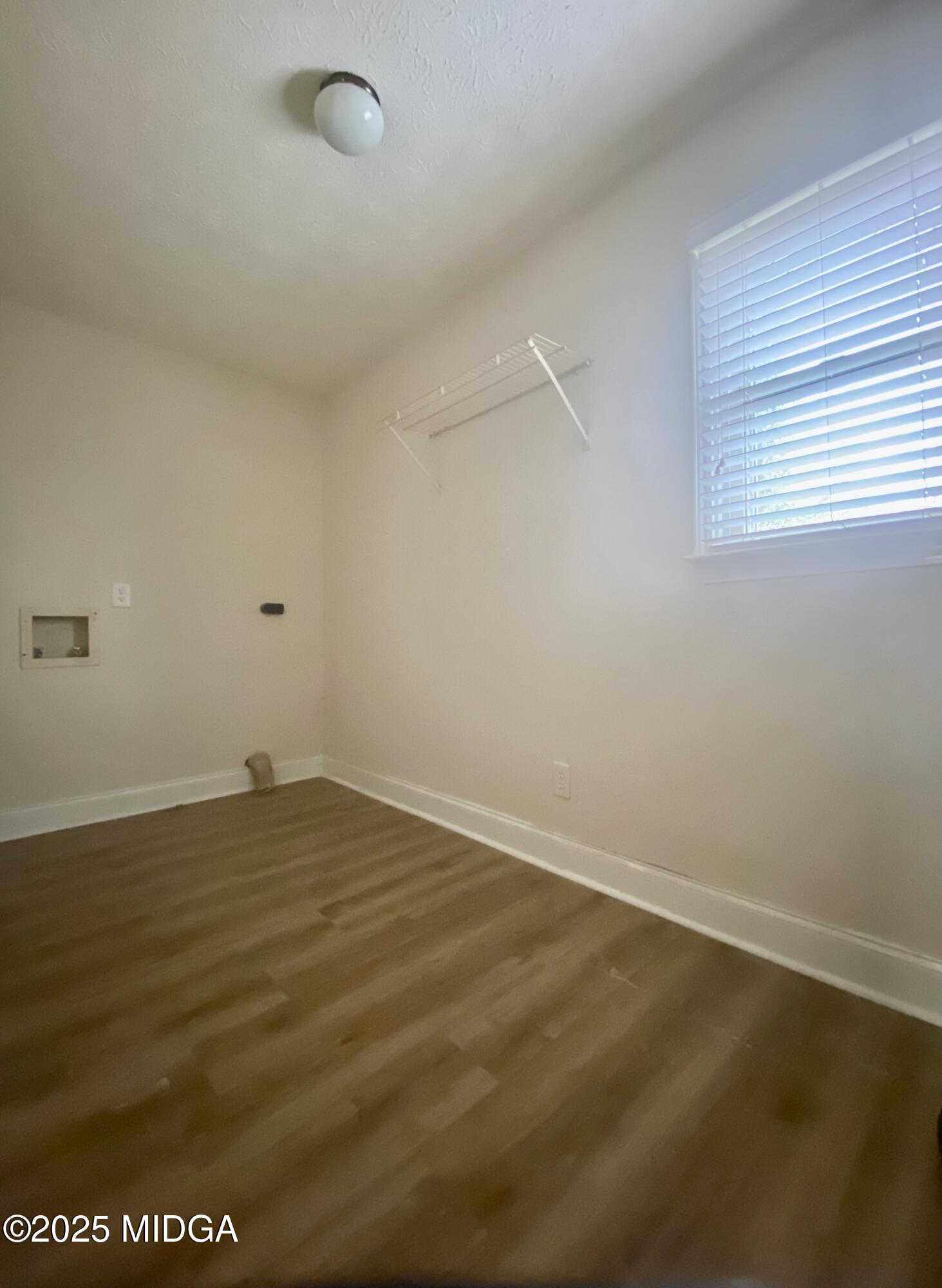 727 Walker Road Byron, GA 31008 - Photo 6 of 23 an empty room with wooden floor and windows