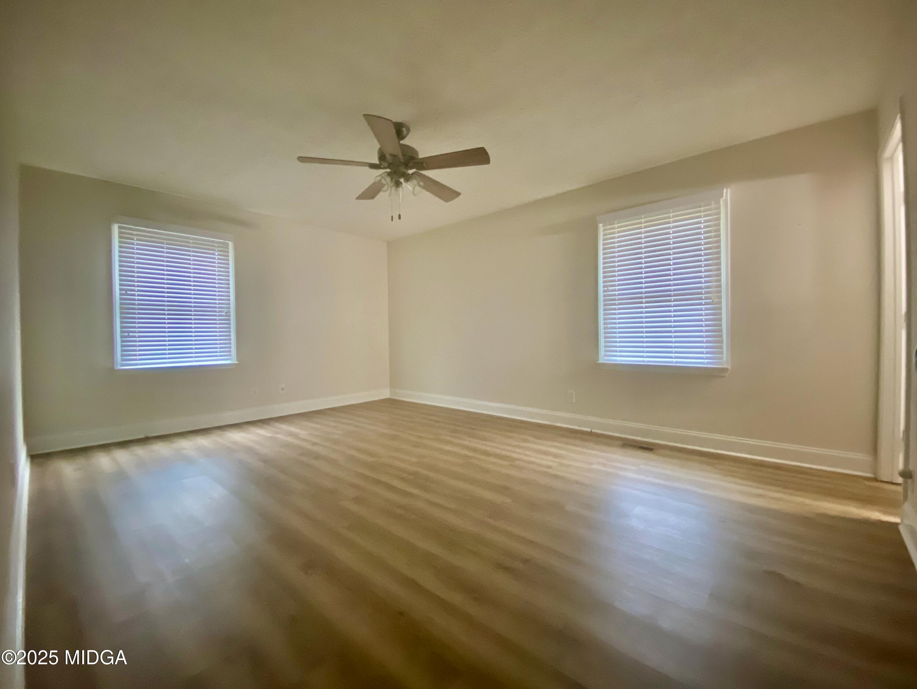 727 Walker Road Byron, GA 31008 - Photo 10 of 23 a view of an empty room with a window and wooden floor