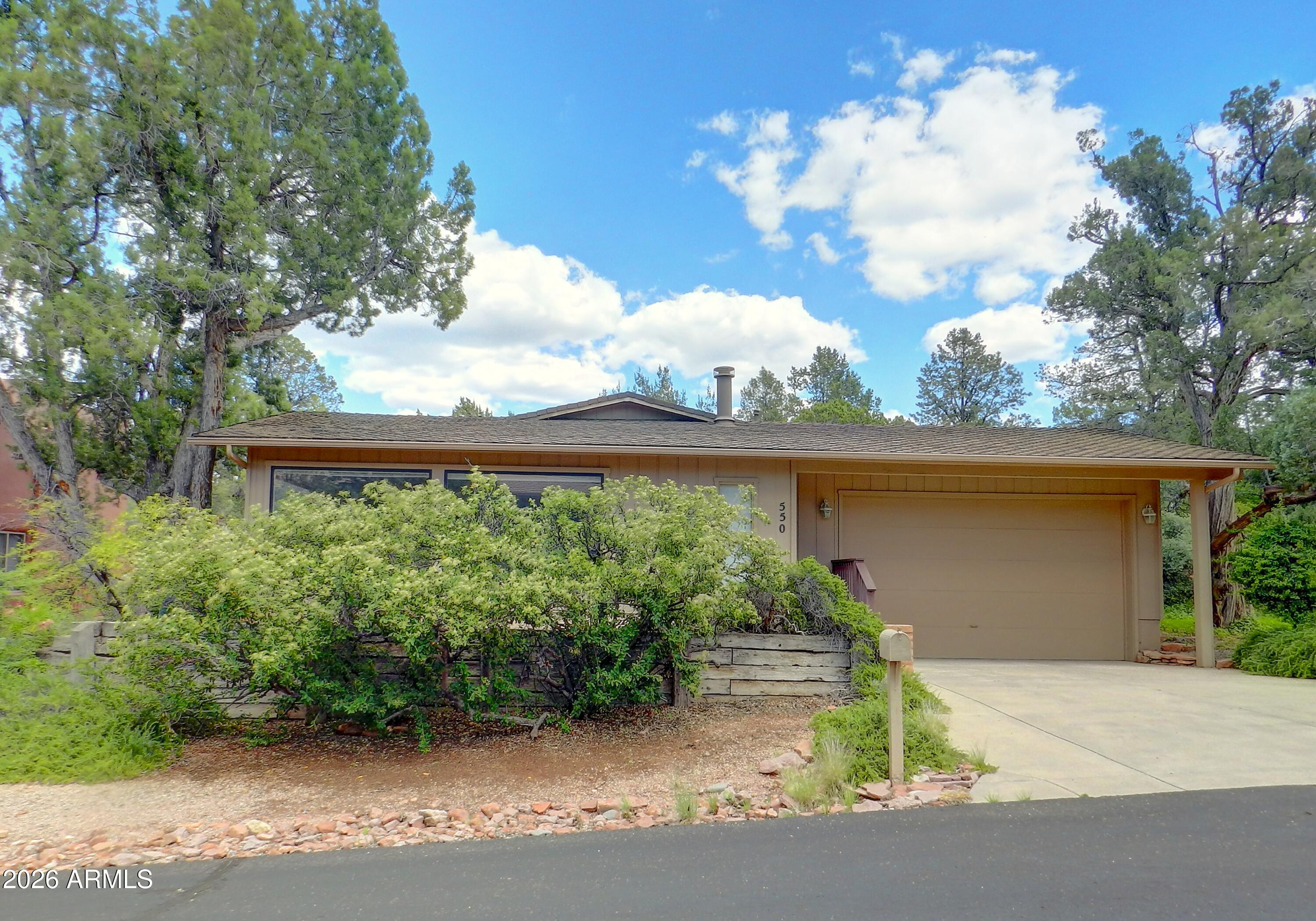 550 Barcelona Road Sedona, AZ 86336 - Photo 3 of 32 a front view of a house with garden