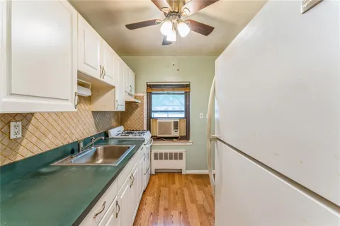 a kitchen with a sink a counter top space and cabinets