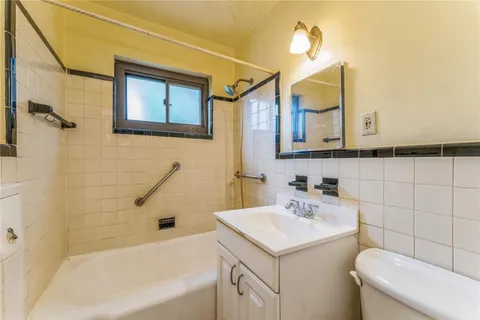 a bathroom with a sink a toilet and bathtub