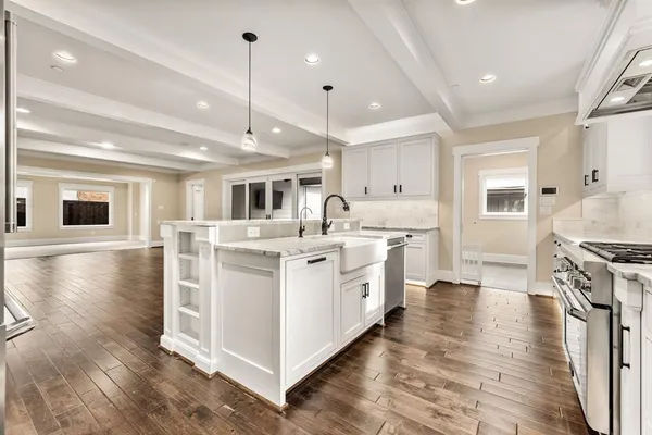 a kitchen with stove and wooden floor