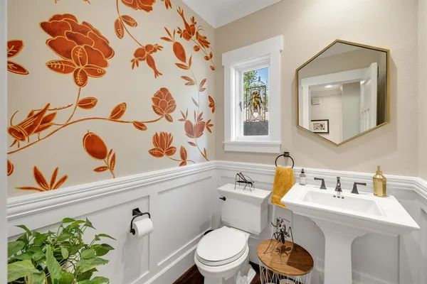 a bathroom with a toilet sink and mirror