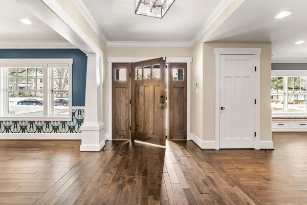 a view of an entryway with wooden floor