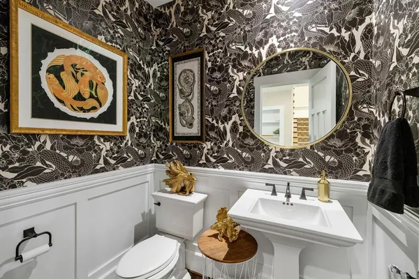 a bathroom with a toilet sink and mirror