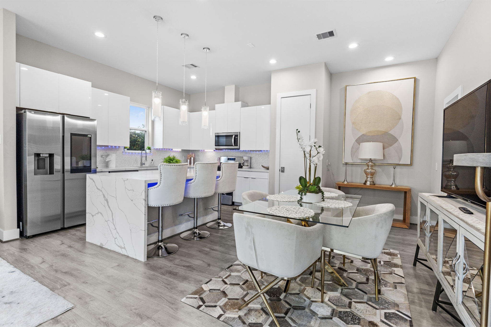 851 Prosper Street Houston, TX 77088 - Photo 13 of 50 a kitchen that has a lot of white cabinets and stainless steel appliances