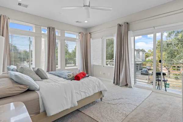 a bedroom with a bed and a large window