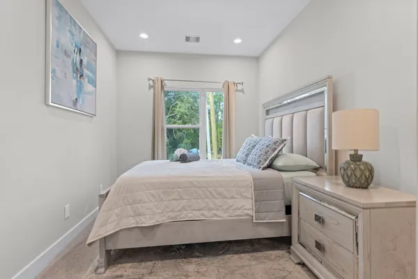a bedroom with a large bed and a window