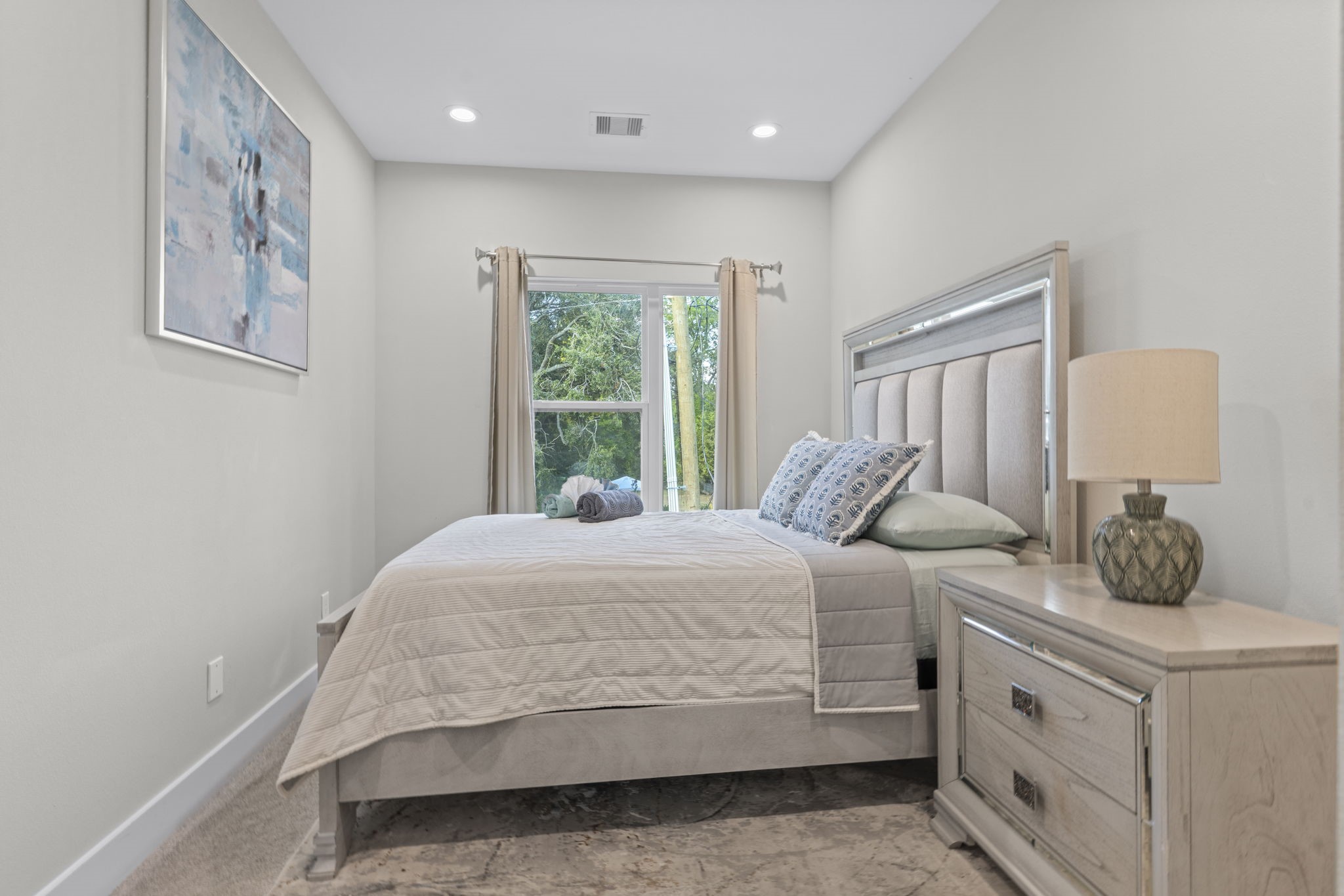 851 Prosper Street Houston, TX 77088 - Photo 45 of 50 a bedroom with a large bed and a window