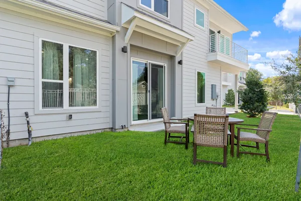 a view of a house with a backyard and sitting area