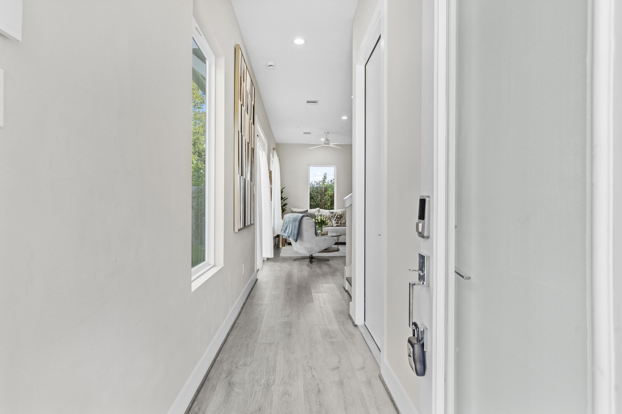 851 Prosper Street Houston, TX 77088 - Photo 10 of 50 a view of a hallway with wooden floor and a living room