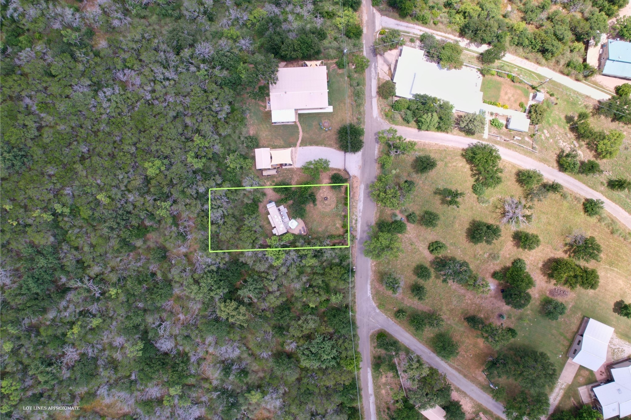 706 Cr138a Road Burnet, TX 78611 - Photo 10 of 18 An aerial perspective reveals a verdant lot nestled among mature trees, awaiting new possibilities.