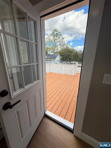 a view of a room with wooden floor and door