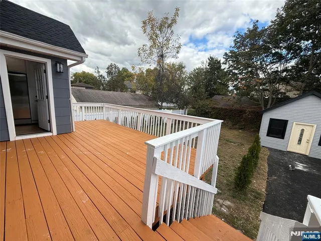 a view of balcony with wooden floor and fence