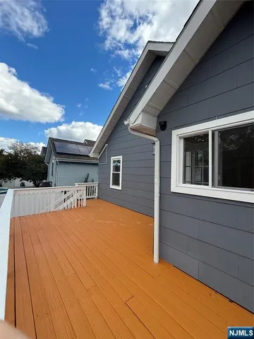 an empty room with wooden floor & windows