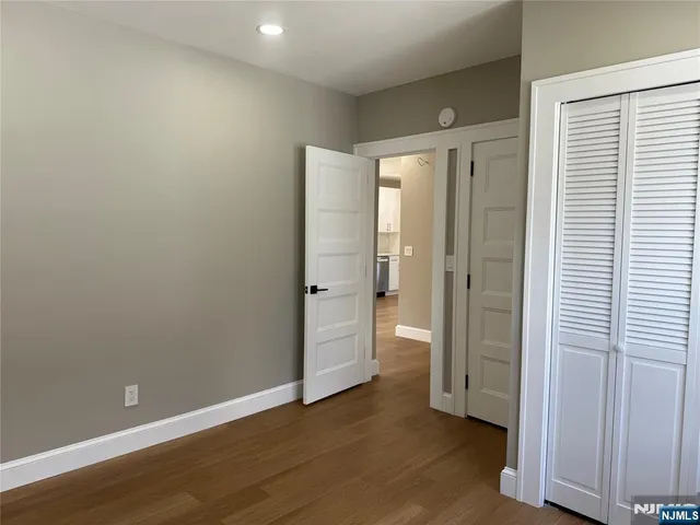 an empty room with windows and closet