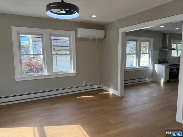 a view of livingroom with hardwood floor and kitchen view