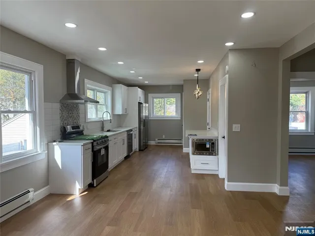 a kitchen with stainless steel appliances granite countertop a stove and a refrigerator