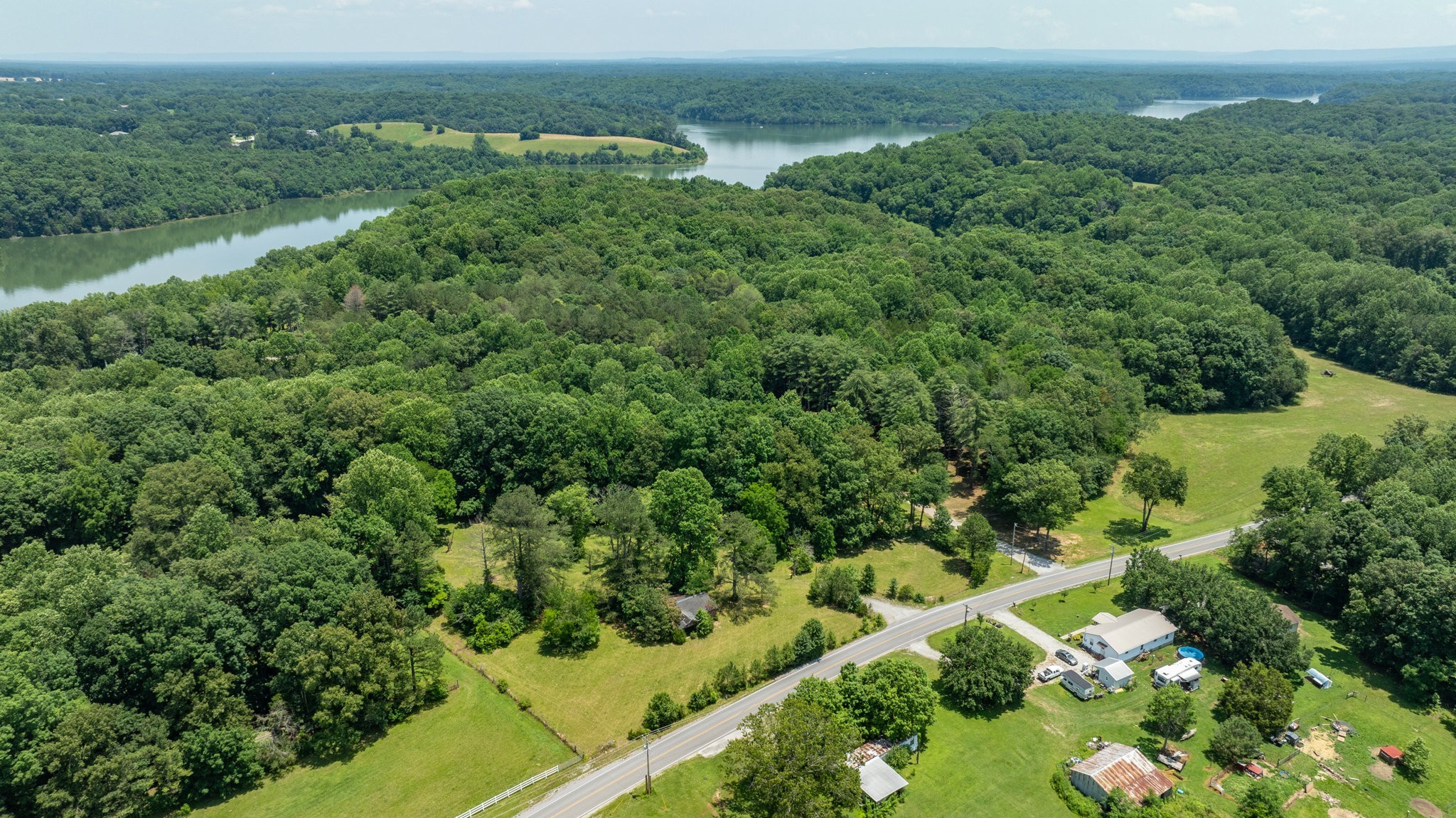 7542 Chestnut Ridge Road Winchester, TN 37398 - Photo 14 of 40 an aerial view of green landscape with trees houses and mountain view